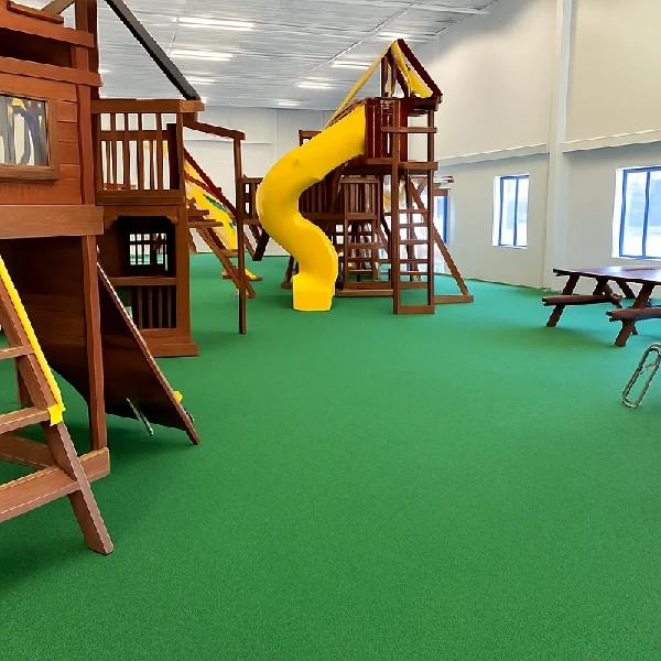 Indoor playground area with bright green seamless EPDM flooring