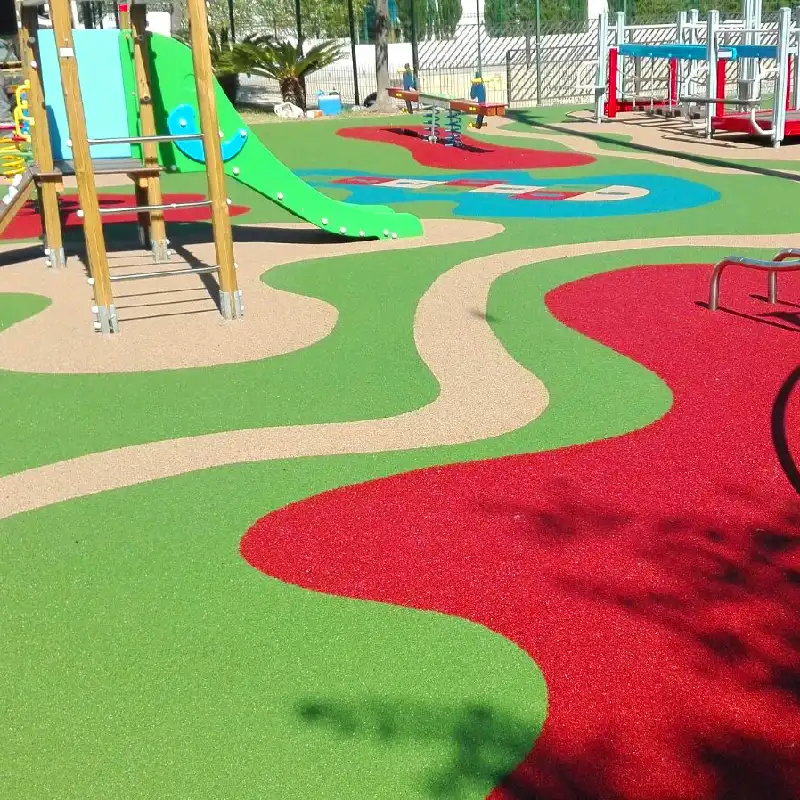 Multi-colored EPDM playground flooring with green and tan wavy paths.